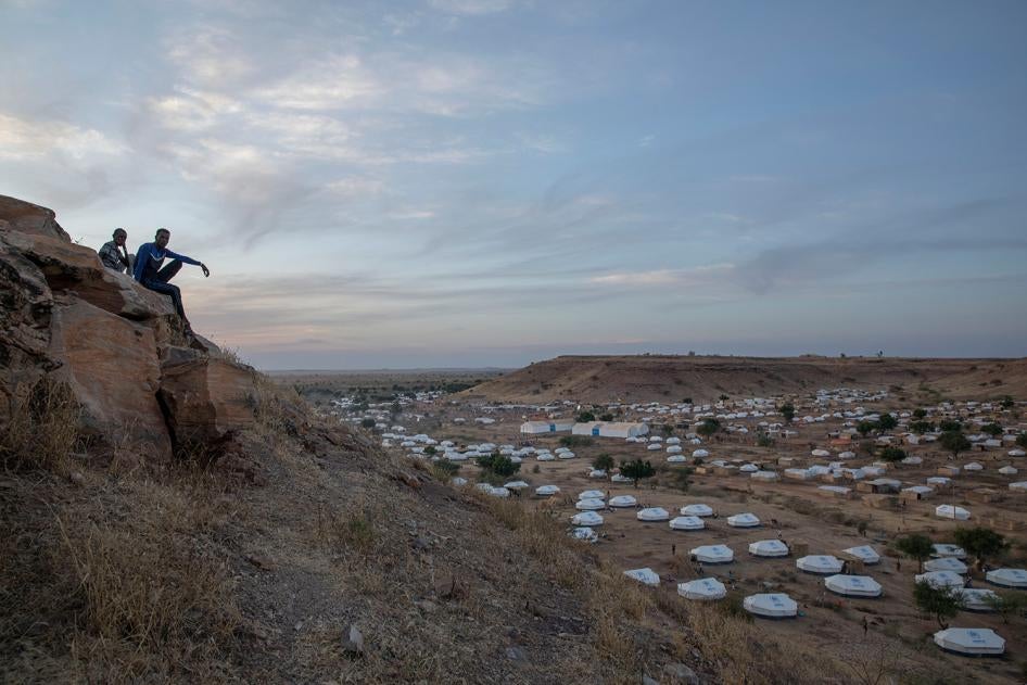 Tigrayan men sit atop a hill overlooking part of the Umm Rakouba refugee camp, in Qadarif, eastern Sudan, on December 14, 2020. 