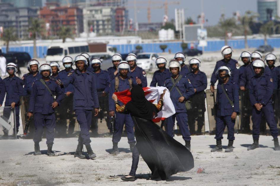 An anti-government protestor gestures in front of police as demonstrators re-occupy Pearl roundabout on February 19, 2011 in Manama, Bahrain. Ten years after the anti-government protests, virtually all opposition has been quashed.