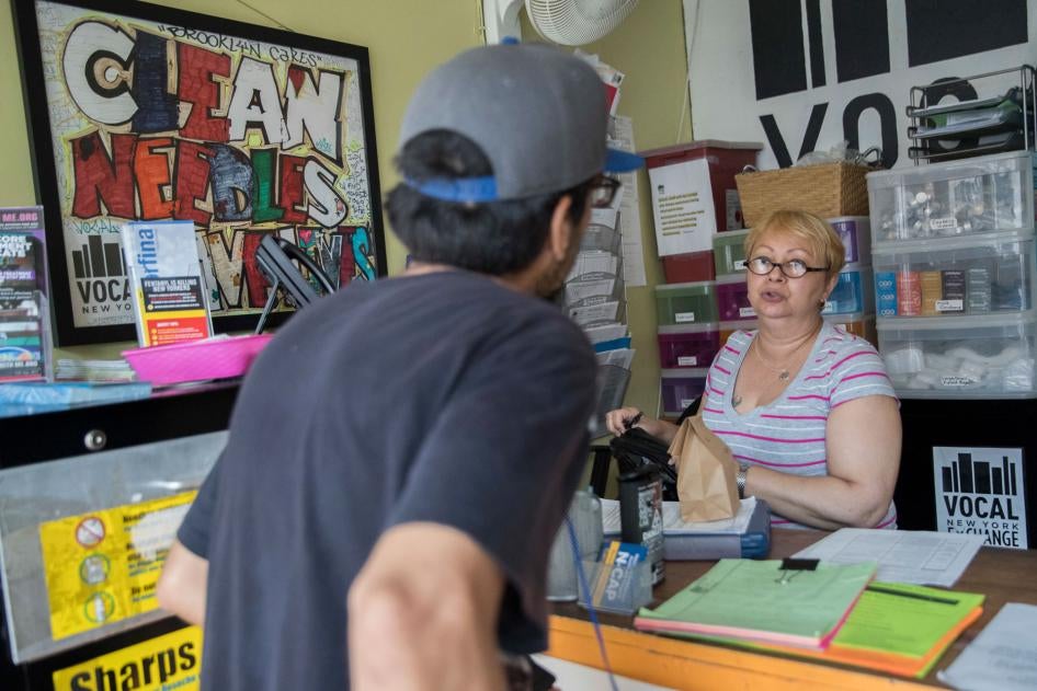 Evelyn Milan, right, prepares a package with sterile injecting equipment for a member at VOCAL-NY's headquarters in the Brooklyn borough of New York, June 3, 2018. 