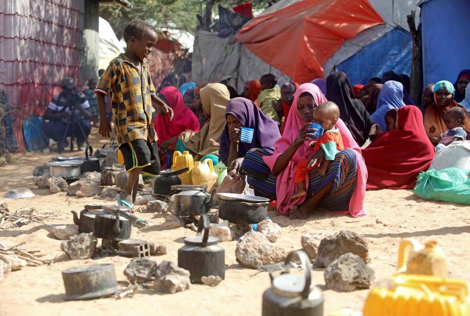 Somali families, displaced after fleeing the Lower Shabelle region amid an uptick in US airstrikes, wait at an Internally Displaced Person camp near Mogadishu, Somalia, March 12, 2020.