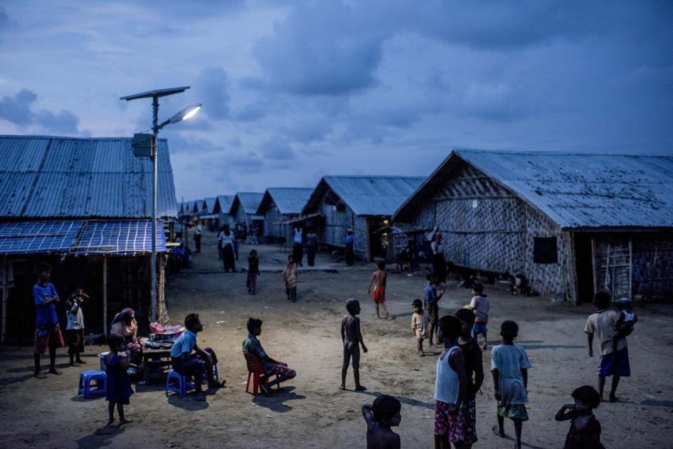 Children play under a street lamp