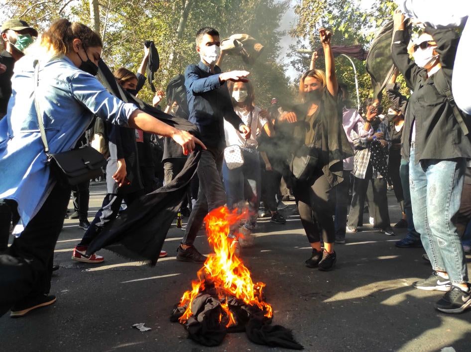 Iranian demonstrators march down a street in Tehran, October 1, 2022. 