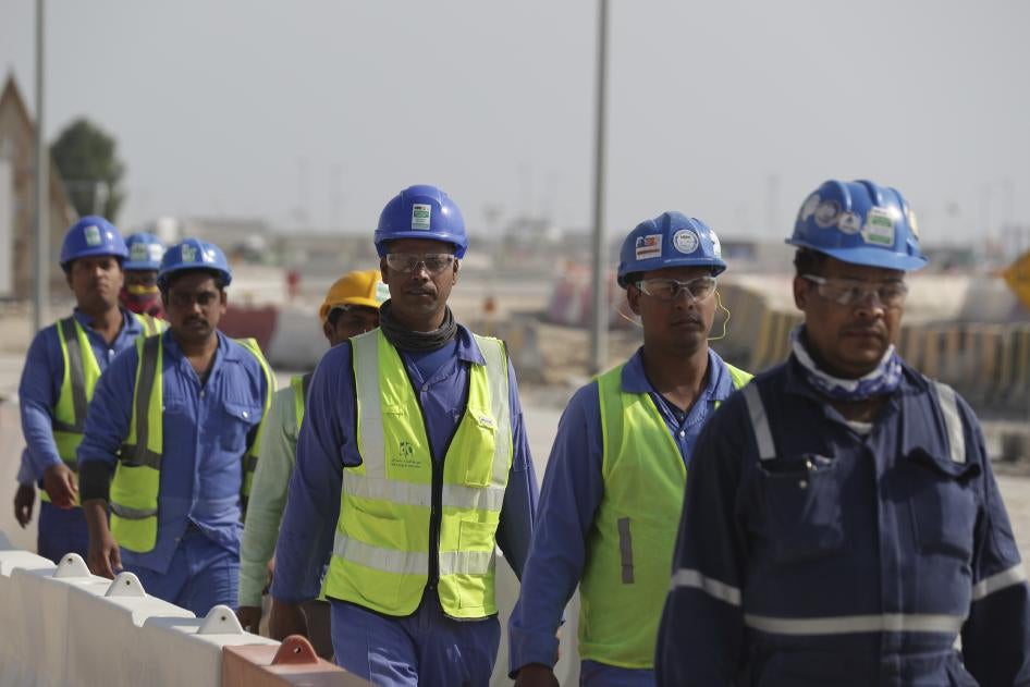 Workers walk to the Lusail Stadium, one of the 2022 World Cup stadiums, in Lusail, Qatar.