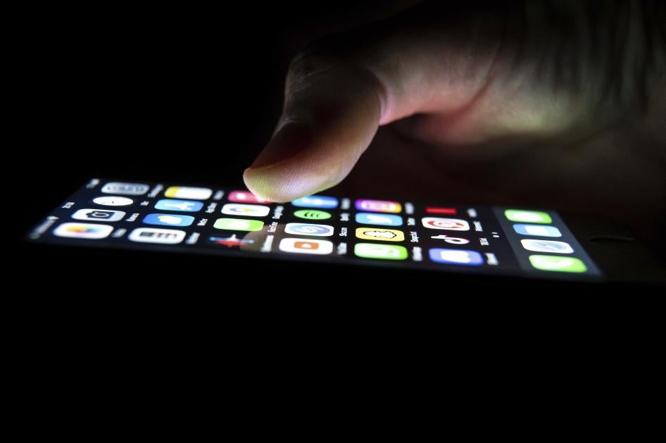 A man looks at the apps on his phone.