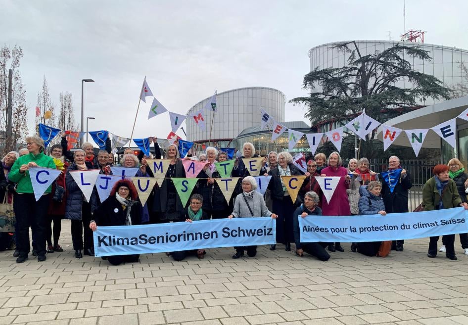 A group from the Senior Women for Climate Protection association hold banners outside the European Court of Human Rights in Strasbourg, France.