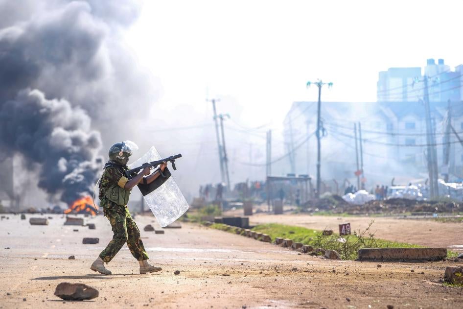 A riot police officer fires tear gas at protesters during a mass rally called by the opposition leader Raila Odinga over the high cost of living, in Nairobi, Monday, March 27, 2023. 