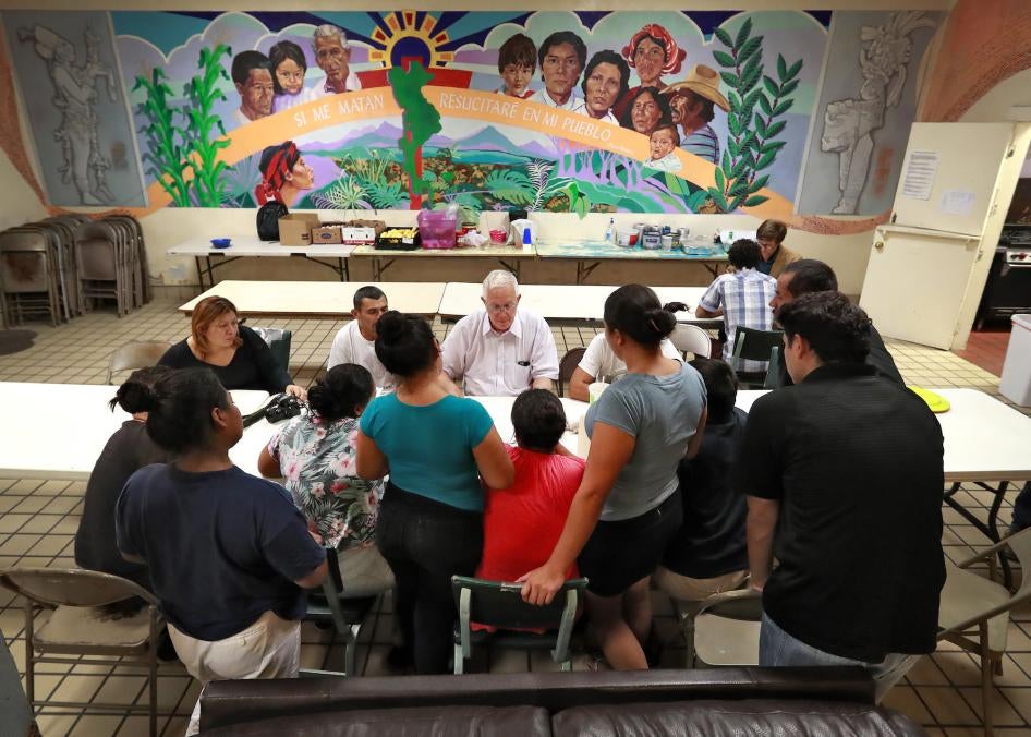  Ruben Garcia, director of the Annunciation House, speaks with migrant parents, El Paso, Texas.