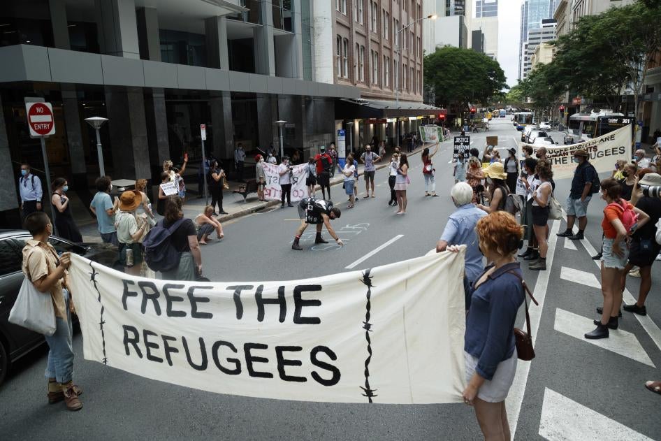 Activists gather in Brisbane's ANZAC Square to protest the indefinite detention of refugees and asylum seekers in Australian-run and funded facilities on the mainland and on Papua New Guinea's Manus Island, January 19, 2022.
