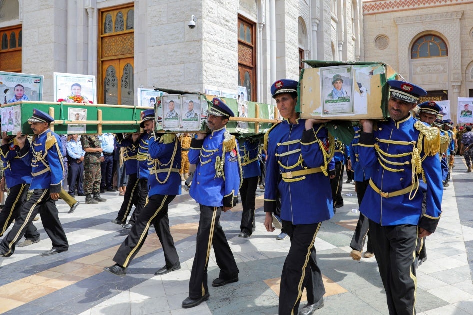 Honor guards carry the coffins of Houthi fighters killed by US-led airstrikes during a funeral in Sanaa, Yemen, February 10, 2024. 