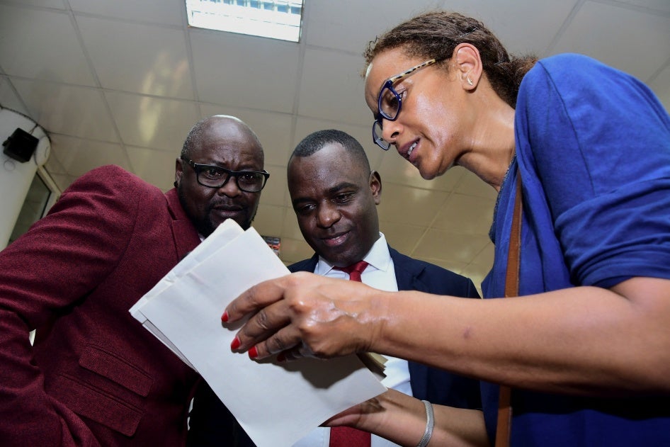 Pepe Onziema (L), Frank Mugisha (C),  from SMUG and UNAIDS representative Tseday Alemseged before the hearing of the petition challenging the Anti Homosexuality Act, Kampala,Uganda, December 13, 2023. 
