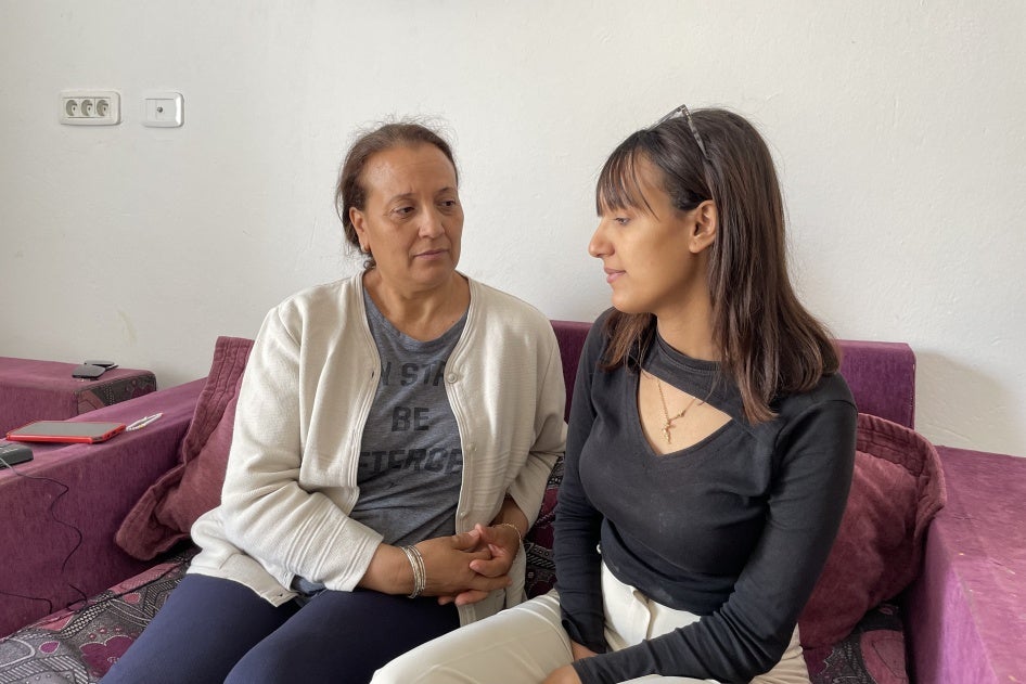 Photo of a mother and daughter sitting on a couch