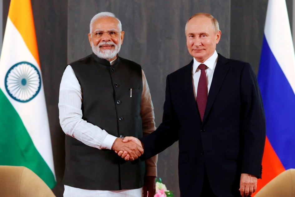 Russian President Vladimir Putin, right, and Indian Prime Minister Narendra Modi pose for a photo shaking hands prior to their talks on the sidelines of the Shanghai Cooperation Organisation (SCO) summit in Samarkand, Uzbekistan, on Sept. 16, 2022.
