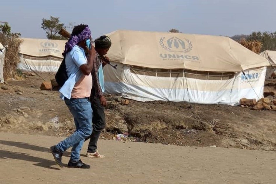Two men walking in Kumer camp