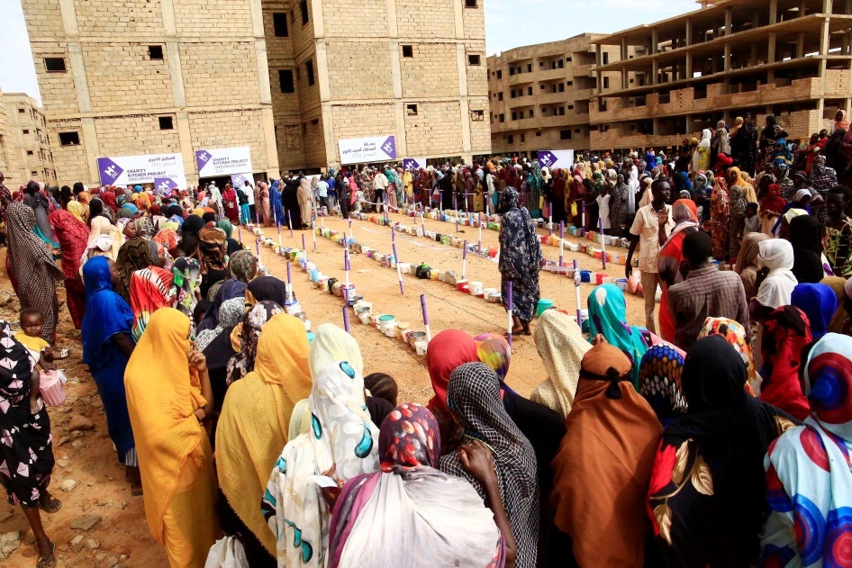 Displaced people gather to receive free breakfast meals at a neighborhood in Omdurman city, Sudan, August 1, 2024. 