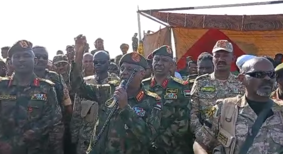 Sudanese Armed Forces General Yasir al-Atta addresses a public meeting with Keikel (second from the right) on January 19, nine days after the Sudan Shield attack on Tayba, saying “[b]ecause now, the Sudanese army, the Sudanese police, the Sudanese intelligence and security, the Joint Forces, the Sudan Shield, and the Sudanese Popular Resistance are all the Sudanese people; they are the Sudanese army”.