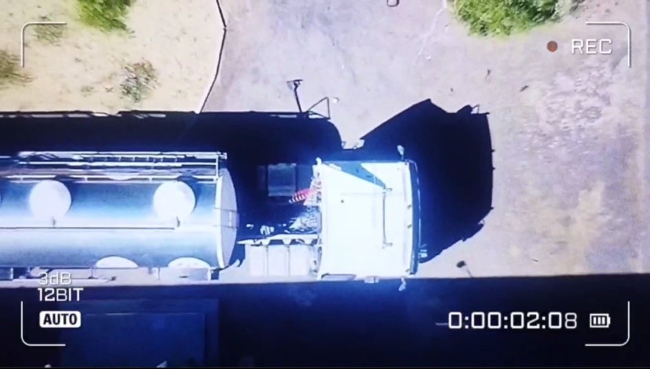 Screengrab of a drone video showing a cylindrical truck