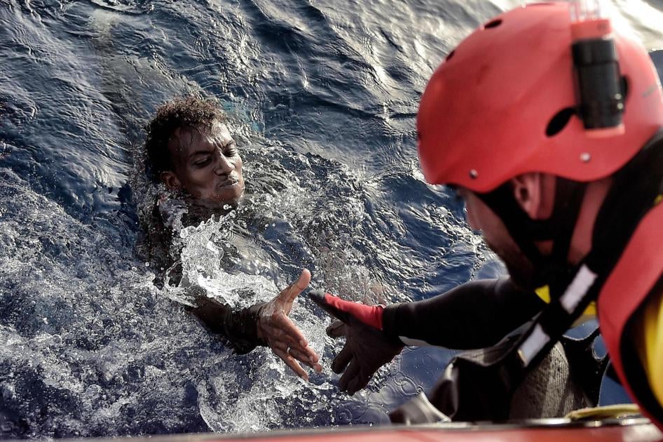 A migrant is rescued from the mediteranean sea by a member of Proactiva Open Arms NGO some 20 nautical miles north of Libya on October 3, 2016. 