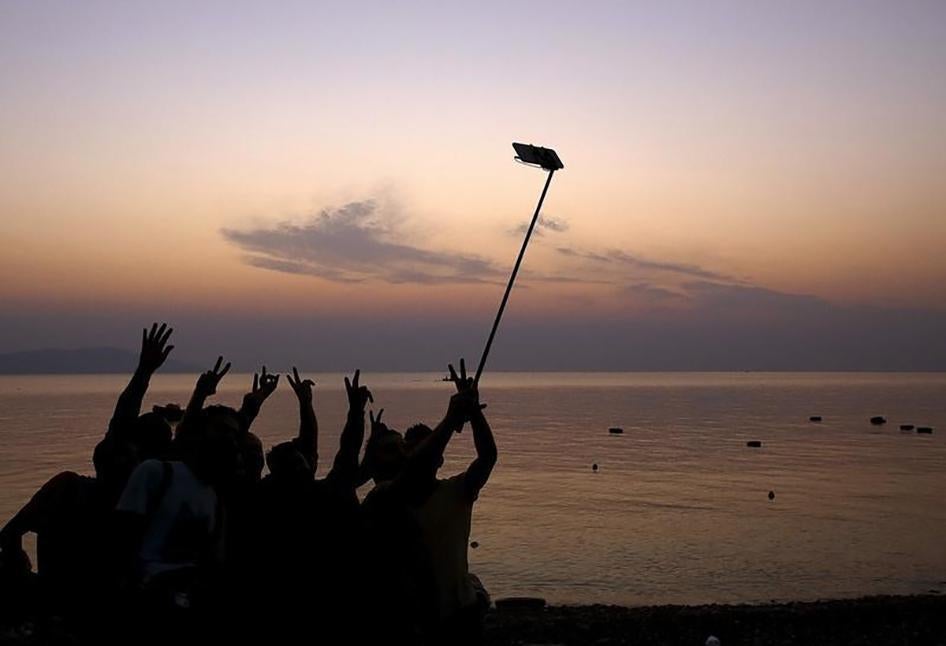 Syrian refugees take "selfies" moments after arriving on an overcrowded dinghy at a beach on the Greek island of Kos.