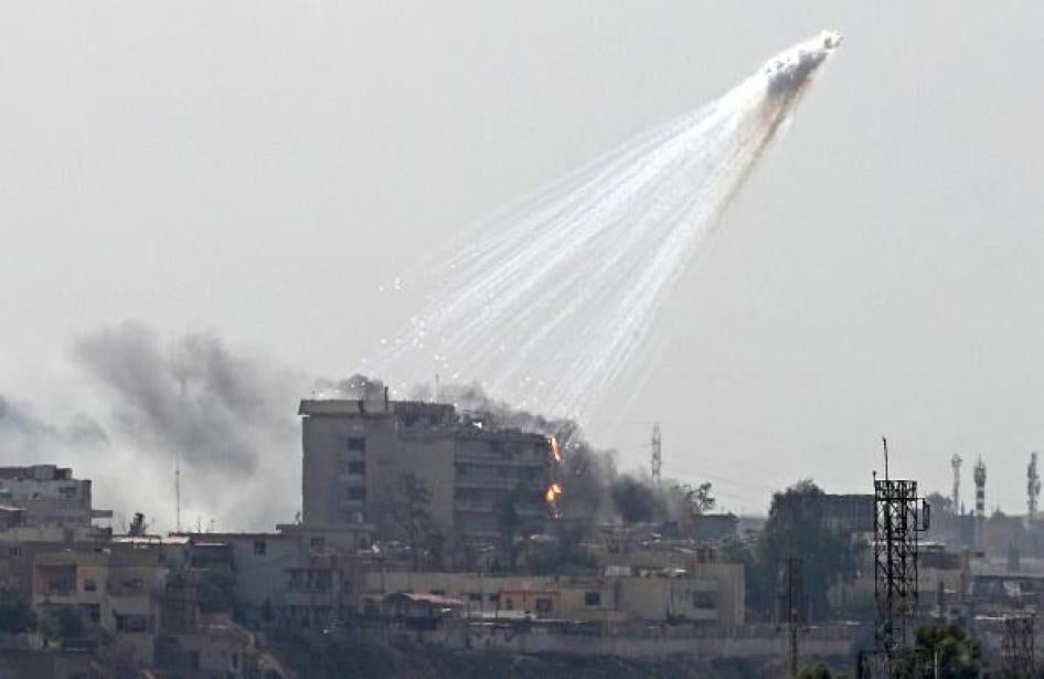 Photo of smoking and burning white phosphorus streaking to the ground in west Mosul on June 2, 2017. 