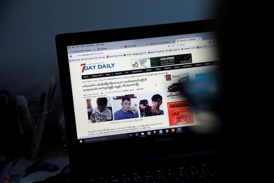 A reporter looks at an article about the three detained journalists in the Democratic Voice of Burma newsroom in Rangoon, Burma, June 29, 2017.