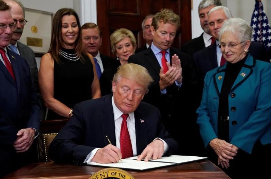 U.S. Senator Rand Paul (R-KY) applauds as U.S. President Donald Trump signs an executive order to make it easier for Americans to buy bare-bones health insurance plans and circumvent Obamacare rules at the White House in Washington, U.S., October 12, 2017