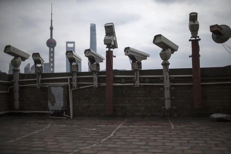 Security cameras are seen on a building at the Bund in front of the financial district of Pudong in Shanghai on March 6, 2015.