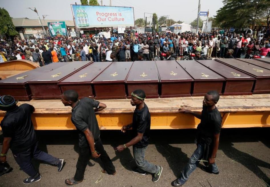 Men march along a truck carrying the coffins of people killed in Makurdi, Nigeria January 11, 2018. 