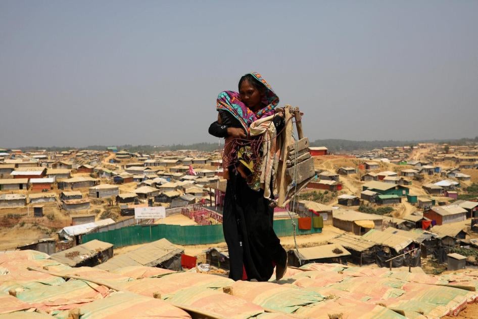 A Rohingya woman walks through Kutupalong refugee camp in Cox’s Bazar, Bangladesh, March 22, 2018.