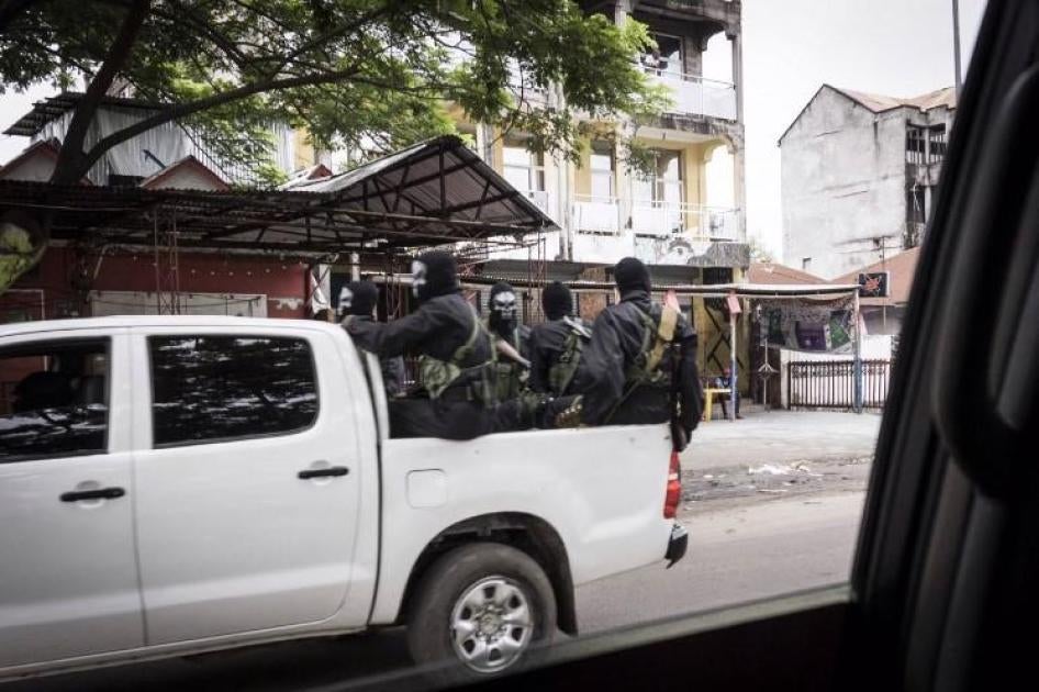 Armed members of the security forces wear black and white skeleton masks, apparently to intimidate protesters, in Kinshasa, January 21, 2018.