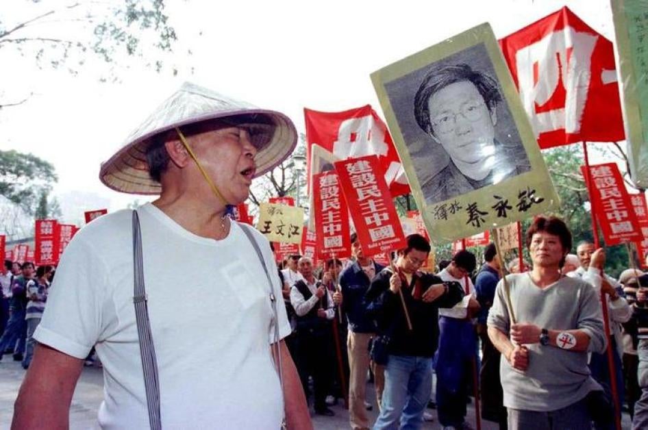 A Chinese Communist supporter (L) hurls insults to protesters as they began a march in Hong Kong January 1, calling for more democracy in China. The rally was first of a series of activities planned by pro-democracy activists in the territory to mark the 