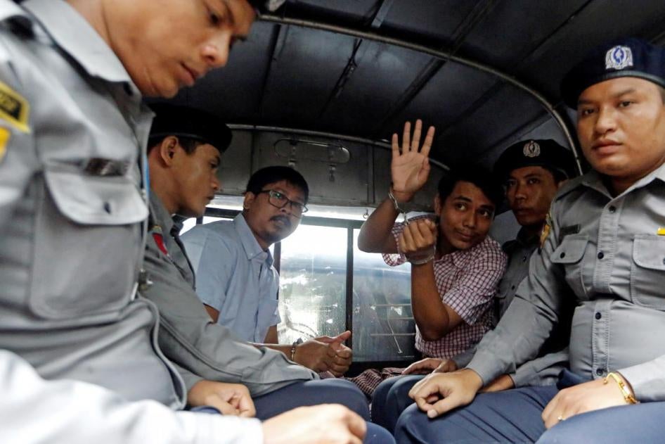 Reuters journalists Wa Lone and Kyaw Soe Oo leave Insein court in a police van in Yangon, Myanmar, July 9, 2018.