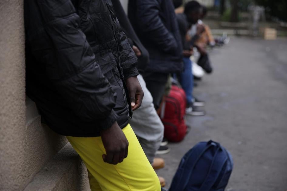 Unaccompanied teens queue outside the Paris evaluation facility 