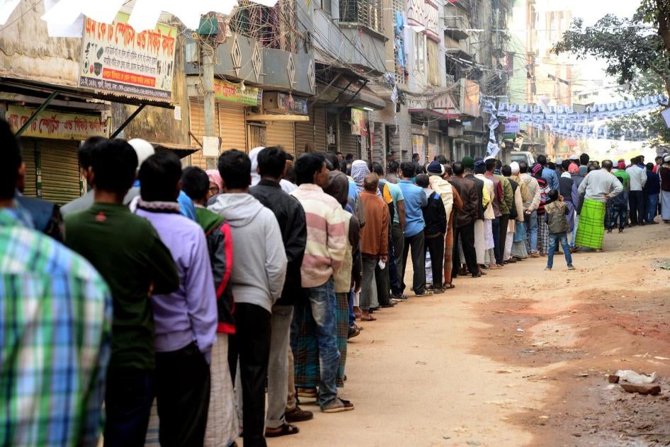 Bangladeshi male voters wait in line outside a polling station to cast their vote in Dhaka, Bangladesh, on December 30, 2018. 