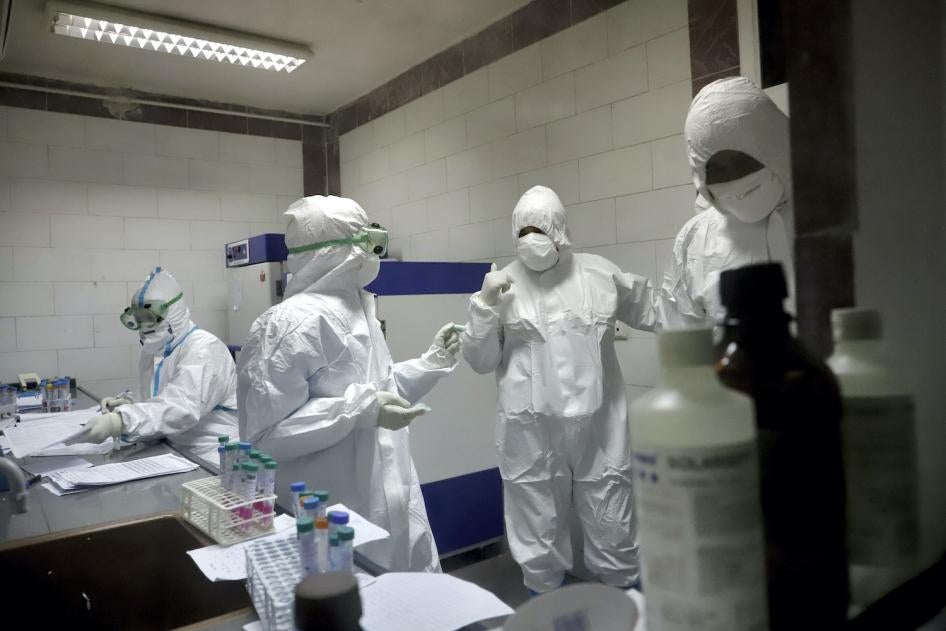 Paramedics work in a laboratory that tests samples taken from patients suspected of being infected with the new coronavirus, in the southwestern city of Ahvaz, Iran, March, 10, 2020.