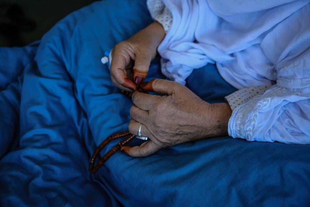 A close-up shot of an elderly woman's hands