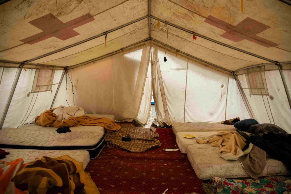 Mattresses arranged on the floor of a tent
