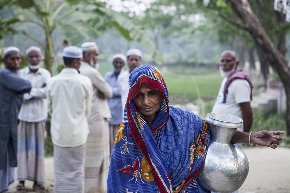 A woman bringing drinking water home in the evening. Balia in Ulania Union (in Barisal District). March 17, 2016. 