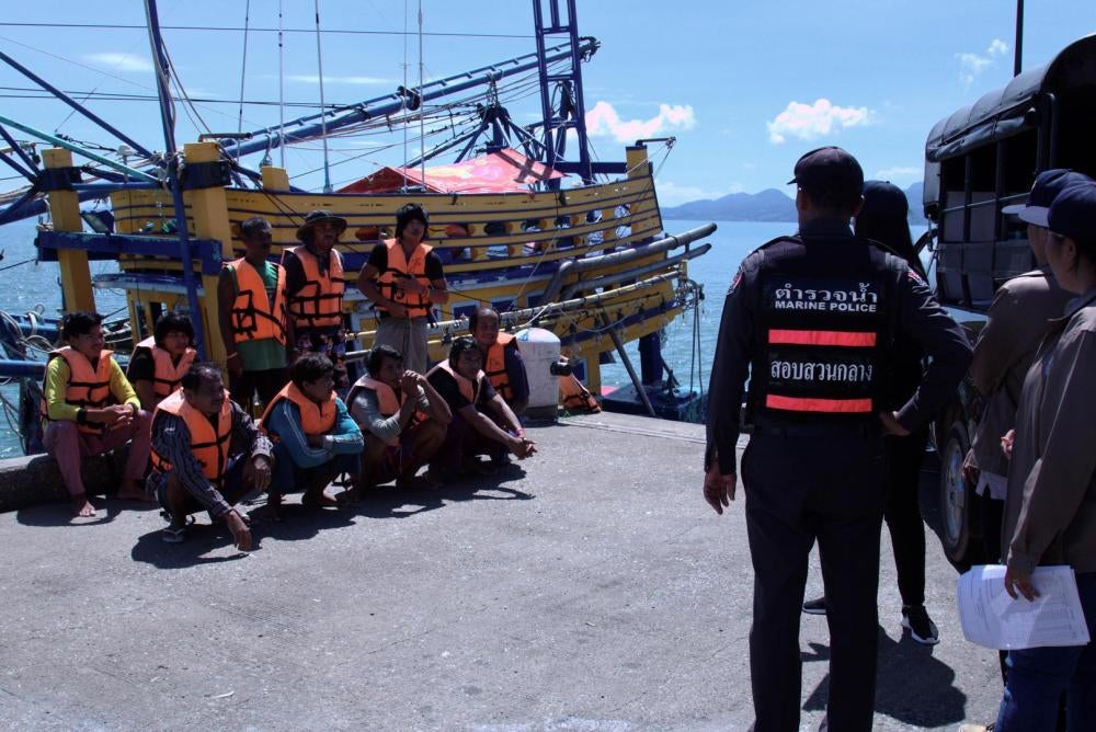 Cambodian fishers are asked by officials to don lifejackets and pose for photos during a PIPO inspection in Laem Ngop, Trat, November 9, 2016.