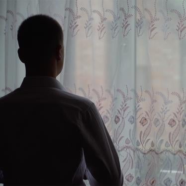 man standing in front of window