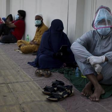 Patients sit on the ground as they wait in queue outside of a hospital for Covid-19 test in Dhaka, Bangladesh on May 16, 2020. 