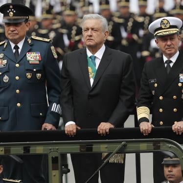 Mexican President Andres Manuel Lopez Obrador, center, stands with Secretary of Defense Luis Crescencio Sandoval, left, and Secretary of the Navy, Vidal Francisco Soberon, in an open military vehicle during the Independence Day military parade in the capital's main plaza, the Zocalo, in Mexico City. 