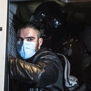 A police officer pats down a protester detained during a rally calling for the results of a referendum on Constitutional amendments to be cancelled in Moscow, Russia, Wednesday, July 15, 2020.