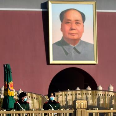 Chinese paramilitary police wearing face masks to protect against the spread of the coronavirus stand guard near the portrait of Chinese leader Mao Zedong on Tiananmen Gate near Tiananmen Square in Beijing on Saturday, January 9, 2021. 