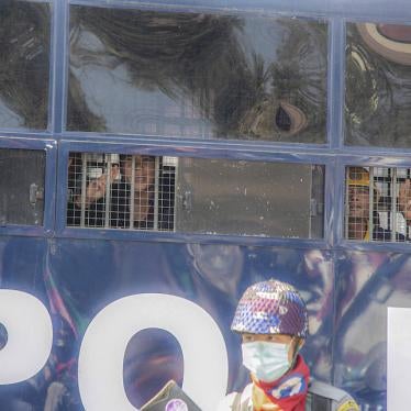 Protesters raise three-finger salutes from inside a police vehicle after a being detained during an anti-coup protest in Mandalay, Myanmar, February 9, 2021.
