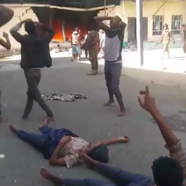 Detainees watch in horror outside the migrant detention facility in Sanaa, Yemen, where scores of Ethiopian migrants burned to death in a fire on March 7, 2021