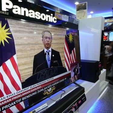A television shows a live broadcast of Malaysian Prime Minister Muhyiddin Yassin at a shopping outlet in Kuala Lumpur, Malaysia, Tuesday, Jan. 12, 2021. 
