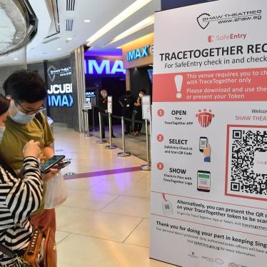 Cinemagoers downloading the TraceTogether app on their mobile phones to check in before entering Shaw Theatres at JCube mall in Singapore, October 31, 2020.