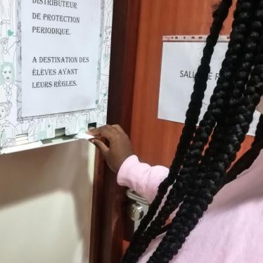 A pupil removes a free organic sanitary napkin from a dispenser at a high school