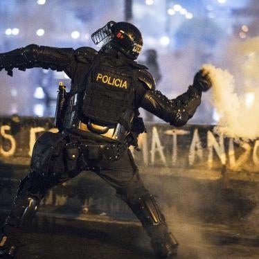 A member of ESMAD throws a tear gas grenade by hand at protesters on May 28, 2021 in Bogota, Colombia.