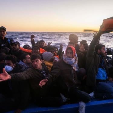 Migrants and refugees on an overcrowded rubber boat during a rescue by the Spanish NGO Open Arms in the Mediterranean Sea, Feb. 12, 2021
